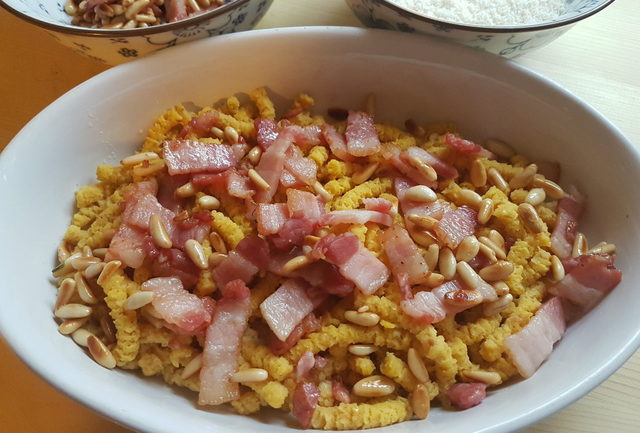 baked passatelli with pancetta and pine nuts 