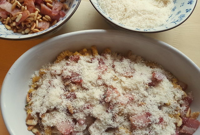 baked passatelli with pancetta and pine nuts 