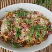 baked passatelli with pancetta and pine nuts