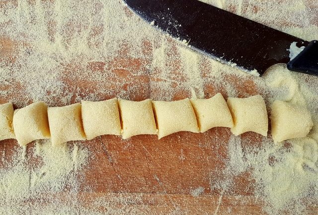 homemade Italian potato gnocchi on wooden board