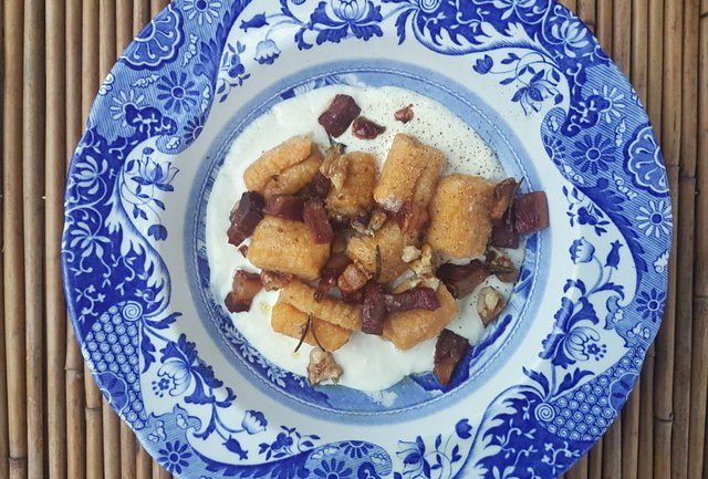 Pumpkin gnocchi with speck and walnuts