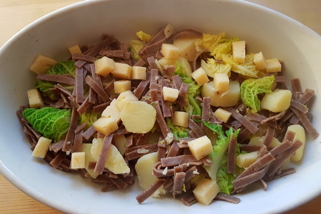 pizzoccheri alla Valtellinese in white dish before baking