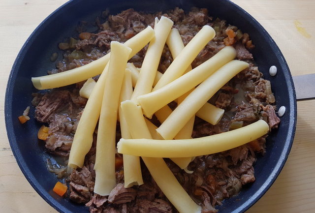 cooked ziti in skillet with la Genovese ragu