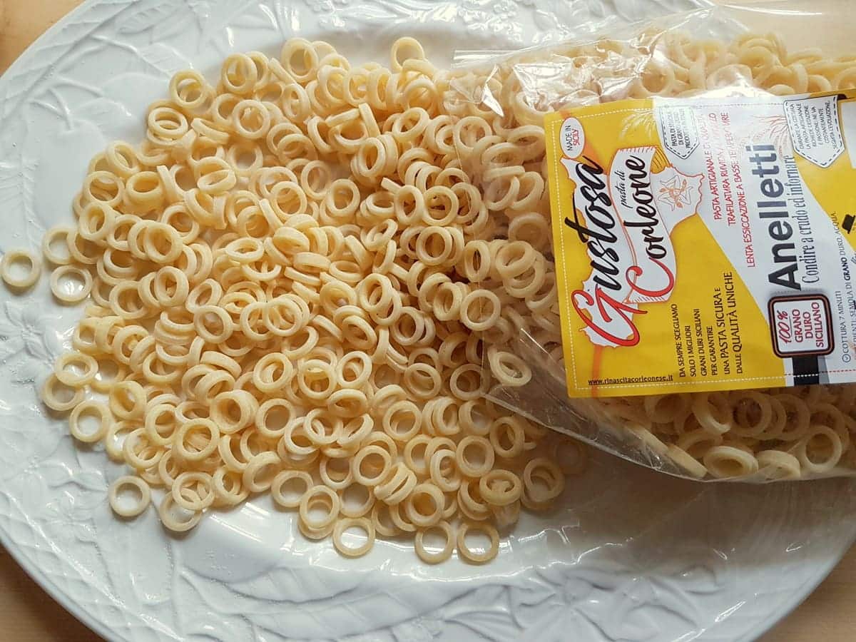 Sicilian anelletti pasta rings on white plate.