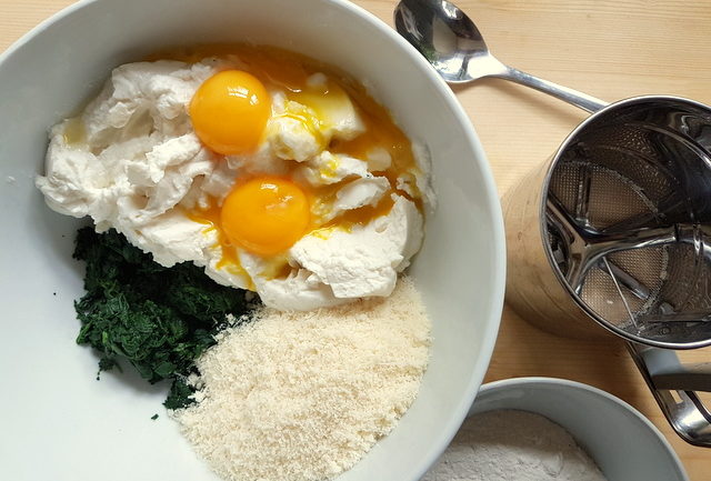 eggs, ricotta, spinach, Parmesan in white bowl for Tuscan gnudi (malfatti)