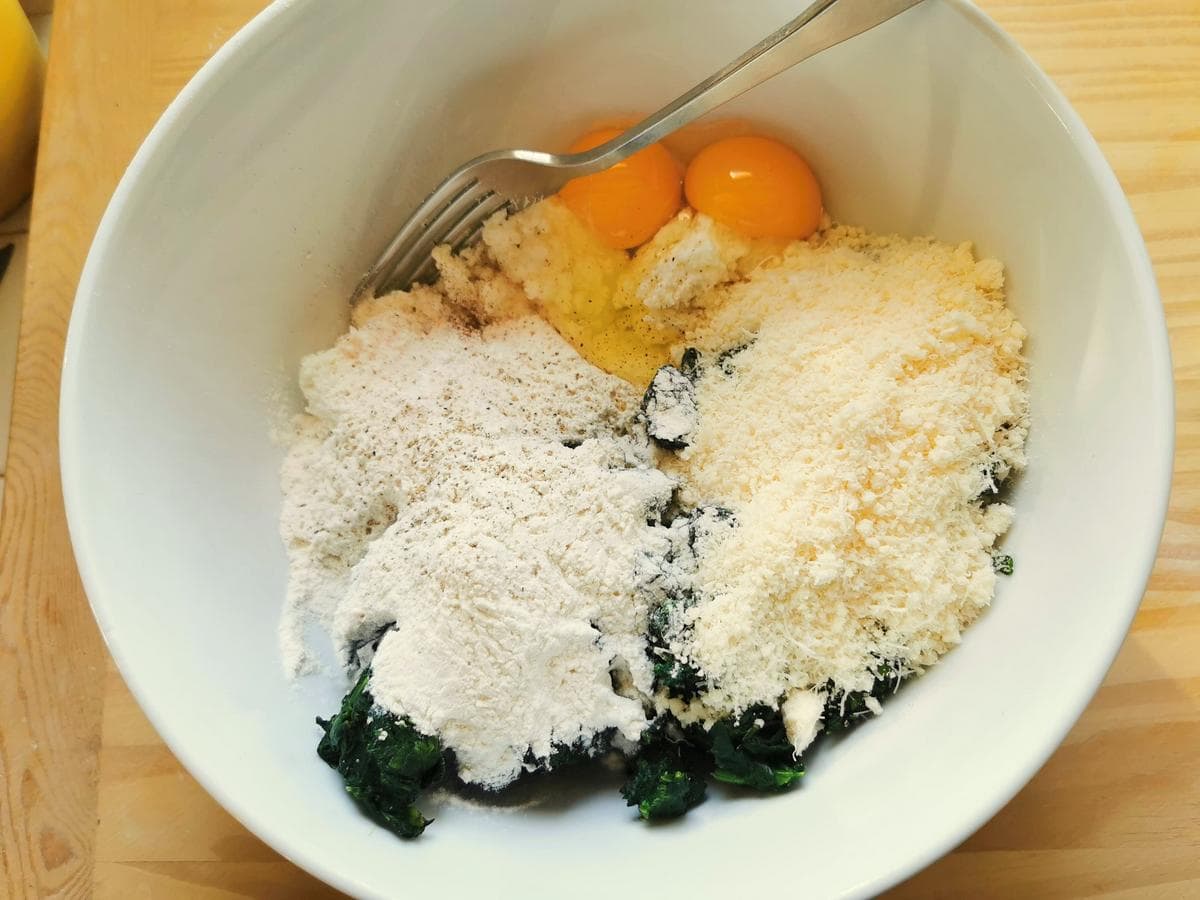 Ingredients for gnudi in white bowl.