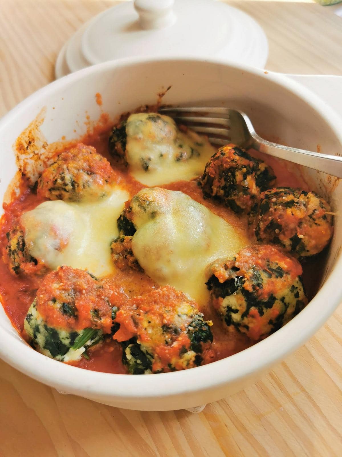 Baked Tuscan gnudi with tomato sauce.