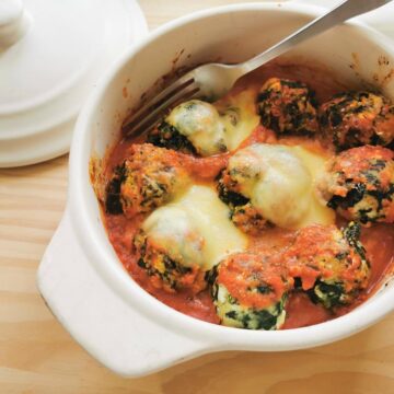 Baked Tuscan gnudi in tomato sauce.