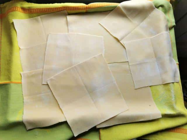 homemade handkerchief pasta squares (fazzoletti) on green tea towel