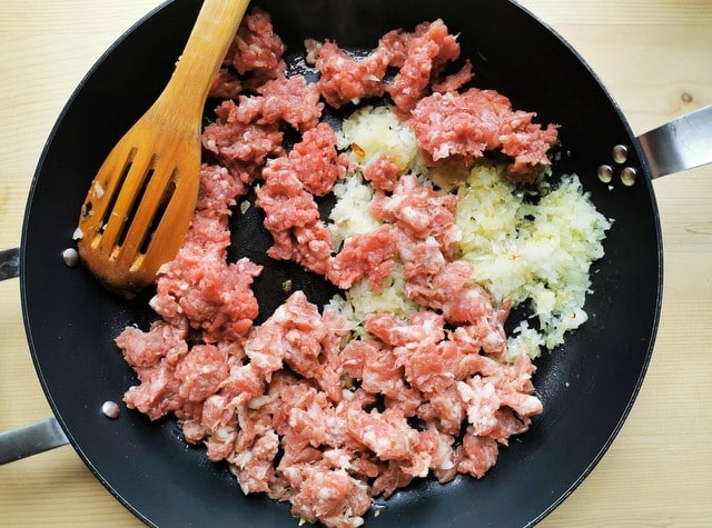 sausage meat, ground beef and onion cooking in skillet