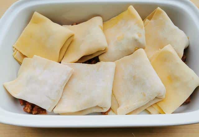 8 stuffed and folded fregnacce Abruzzesi in white oven dish.