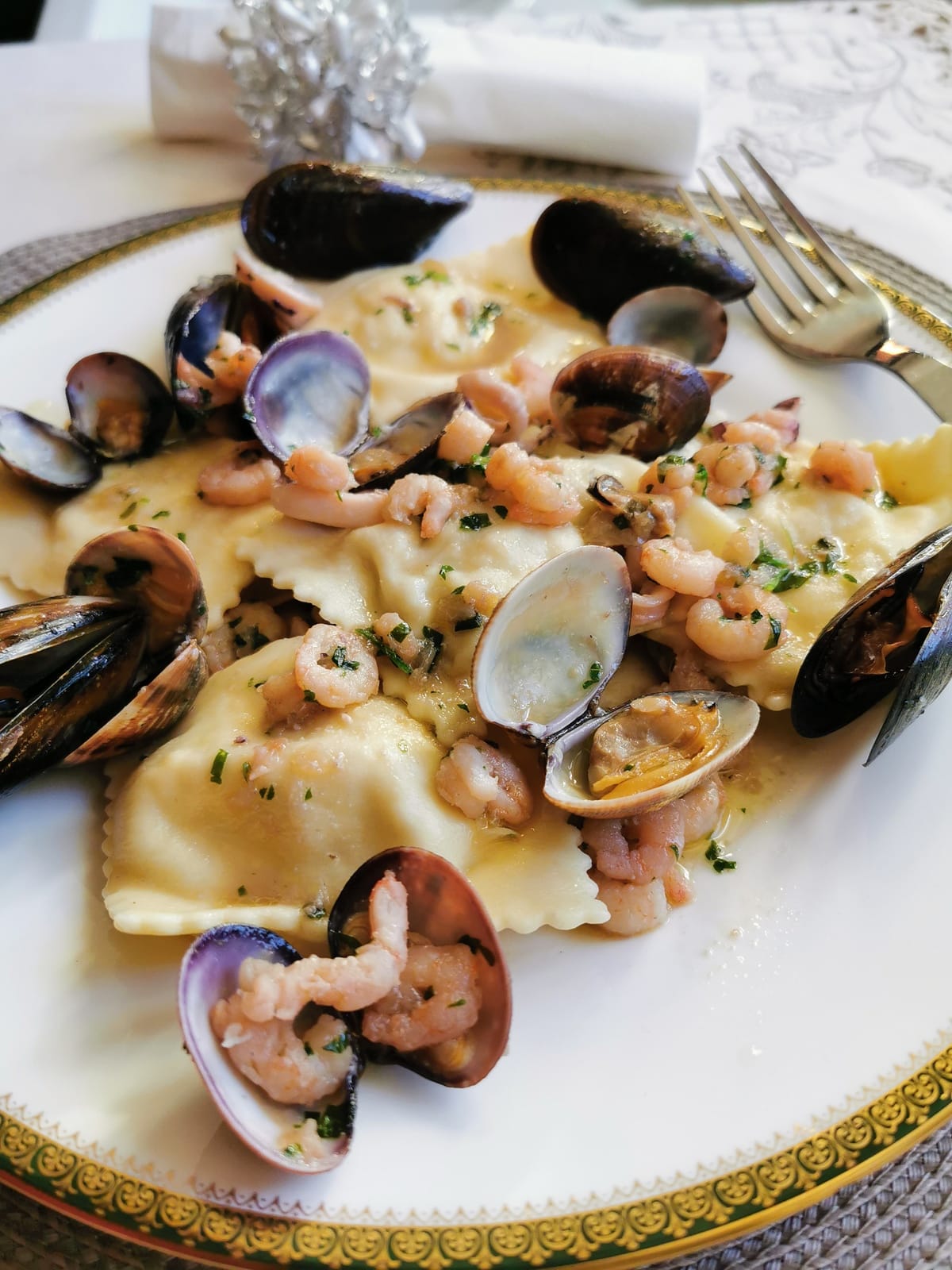 Baked fish ravioli with seafood sauce.