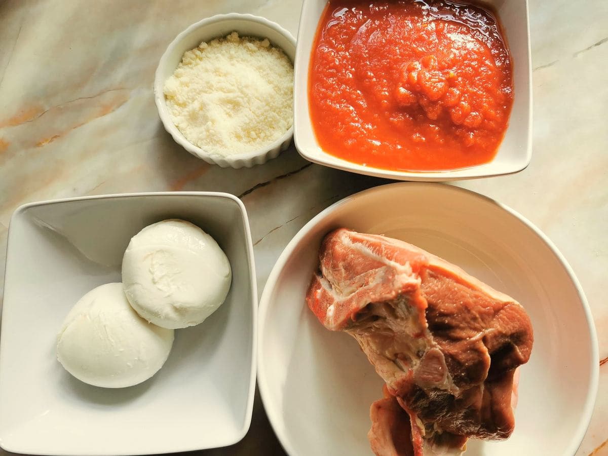 Ingredients for orecchiette with lamb in white bowls.