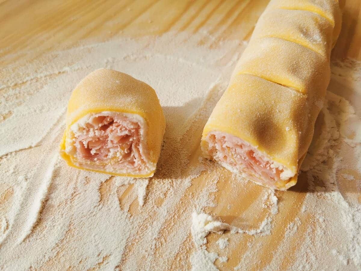 Ham and cheese filled pasta roll cut into small 3 cm wide pasta roses.