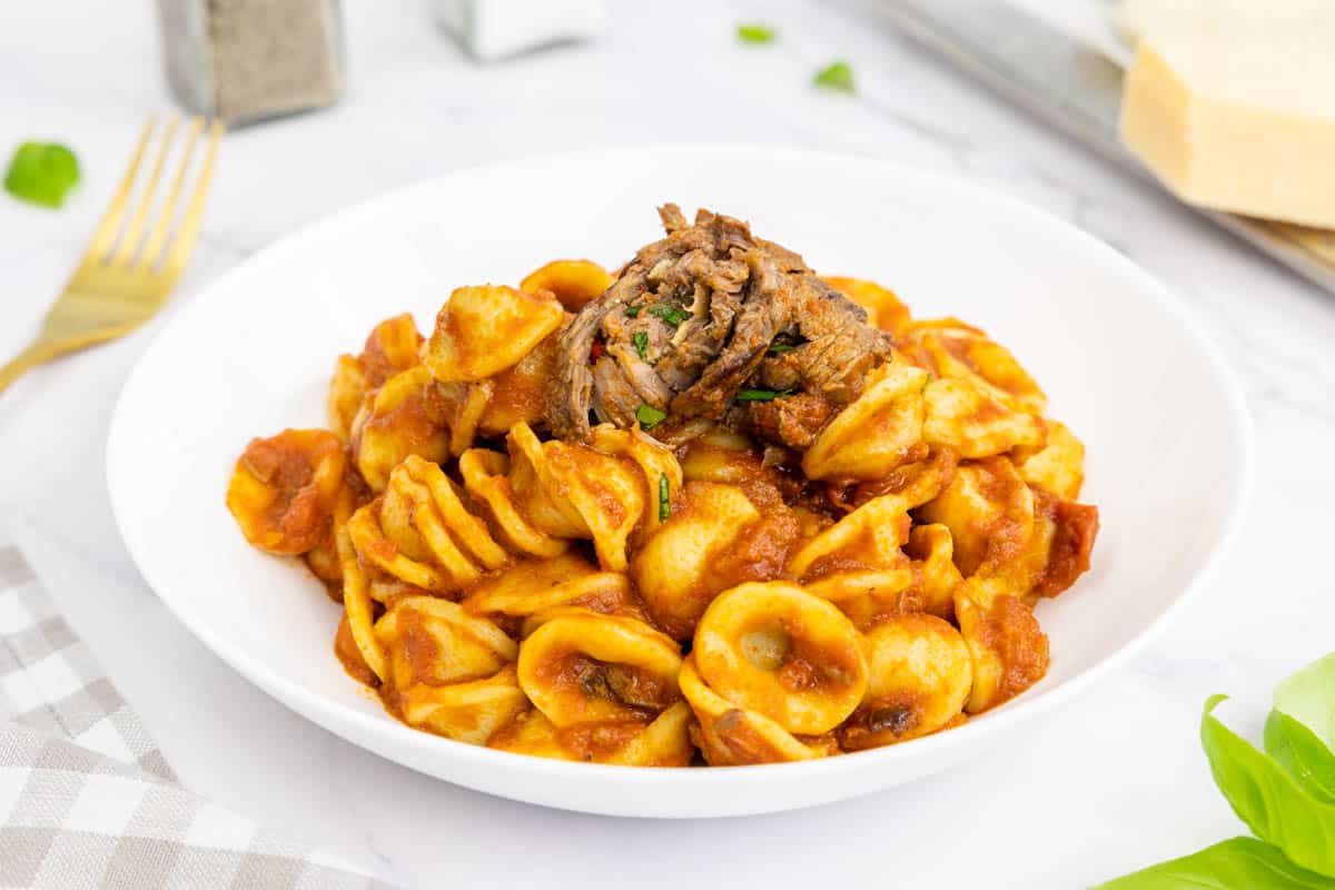 Italian braciole with orecchiette in a bowl.