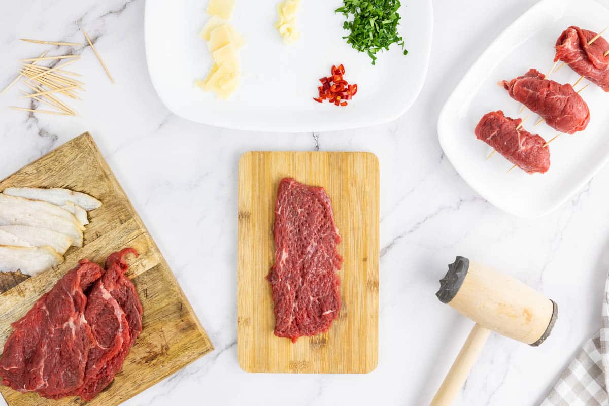 Beef sirloin tenderized on a wooden board