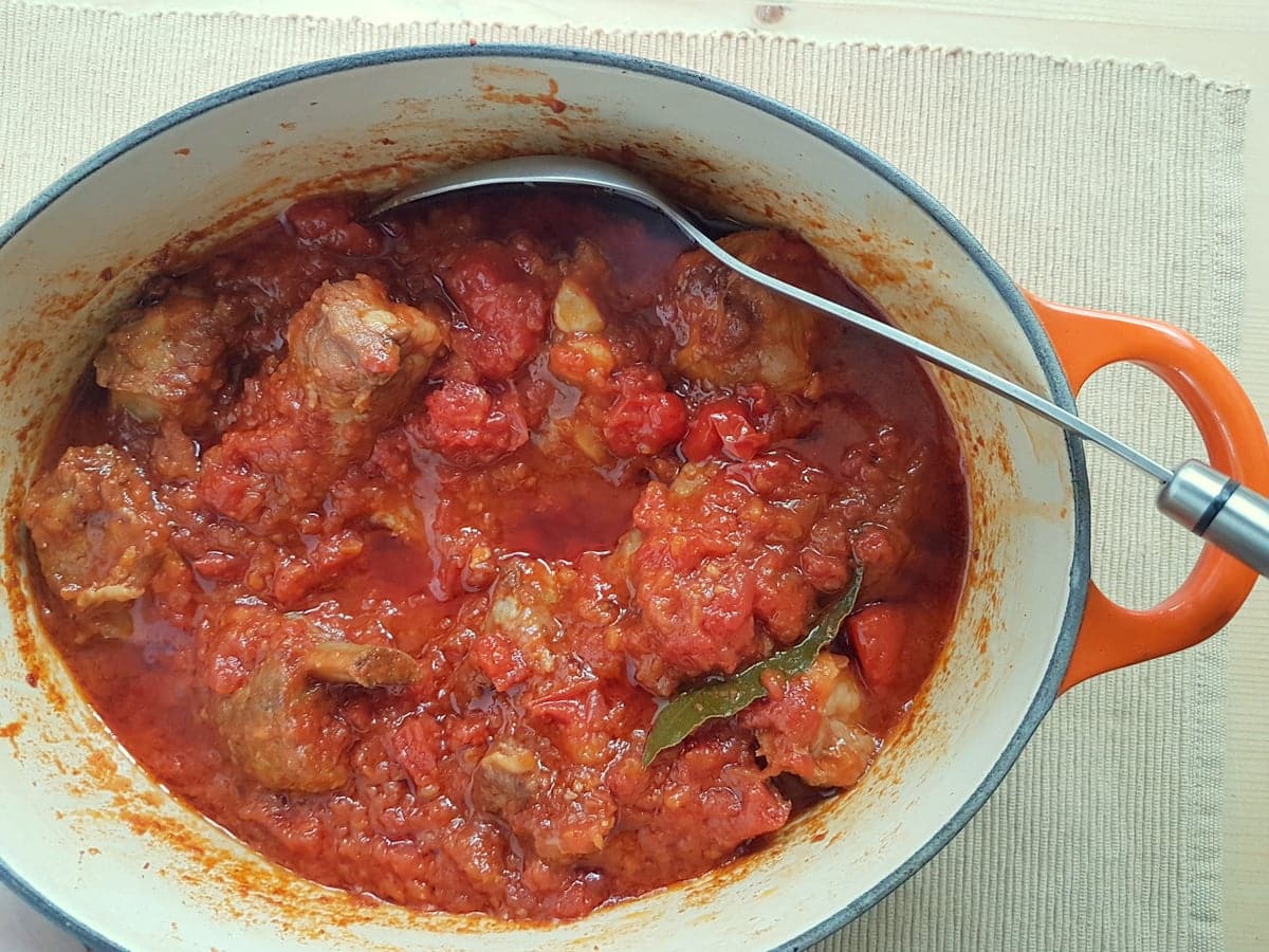 Ready braised pork ribs in sauce in Dutch oven.