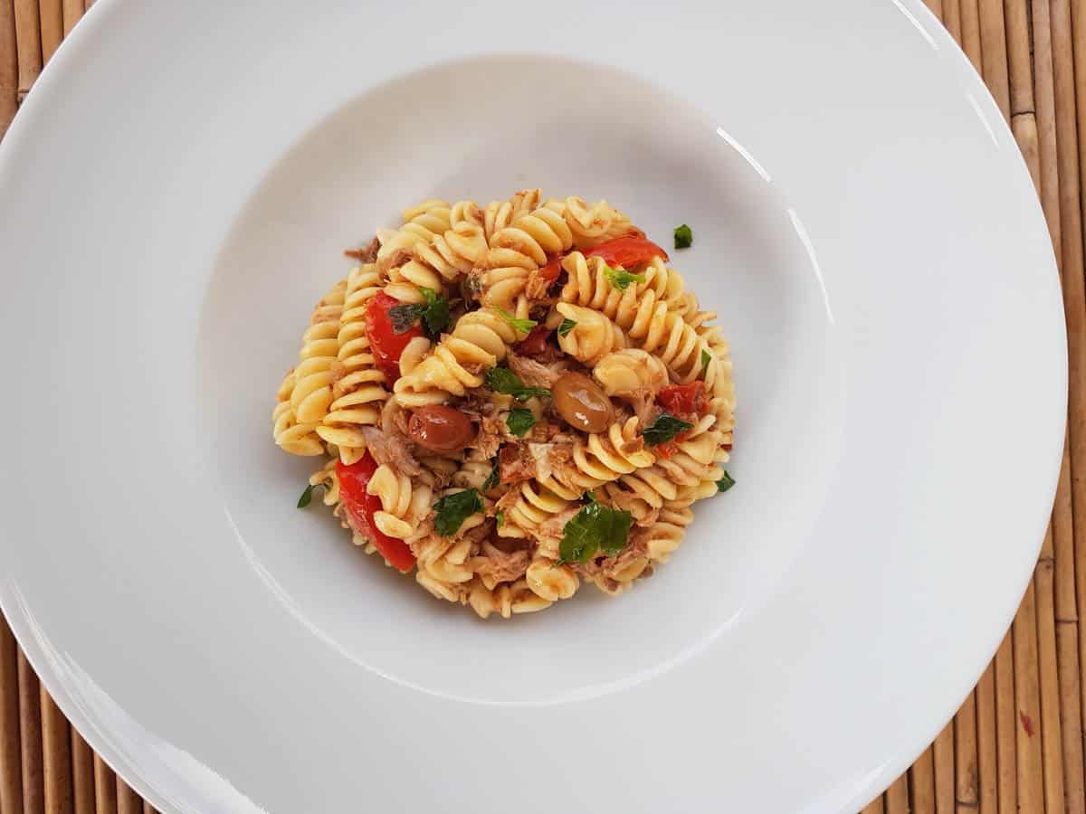 Black olive pesto pasta in a bowl.