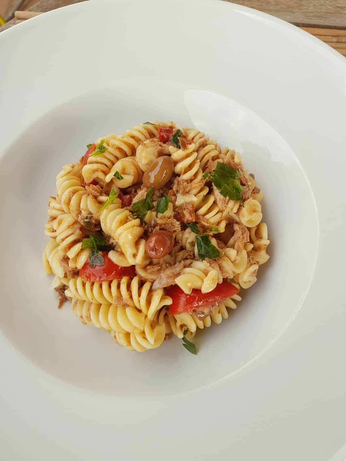 Olive pesto with pasta in a white bowl