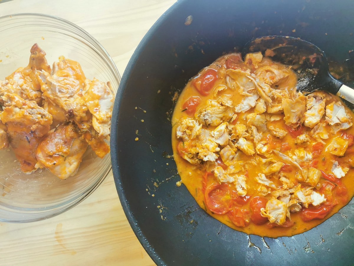 Cooked braised rabbit pieces in glass bowl and rabbit meat in sauce in deep skillet.