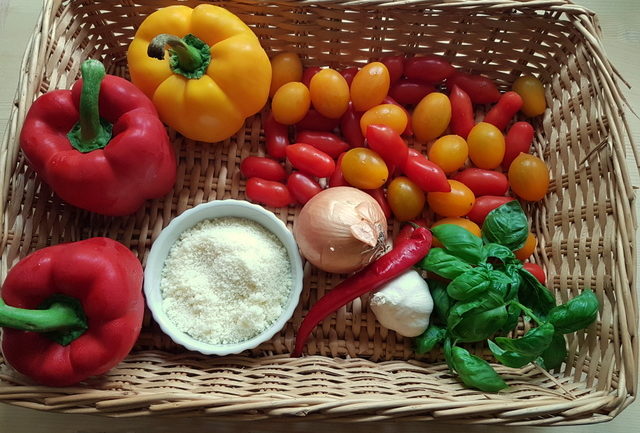 Ingredients for bucatini with red and yellow cherry tomatoes and peppers recipe in basket