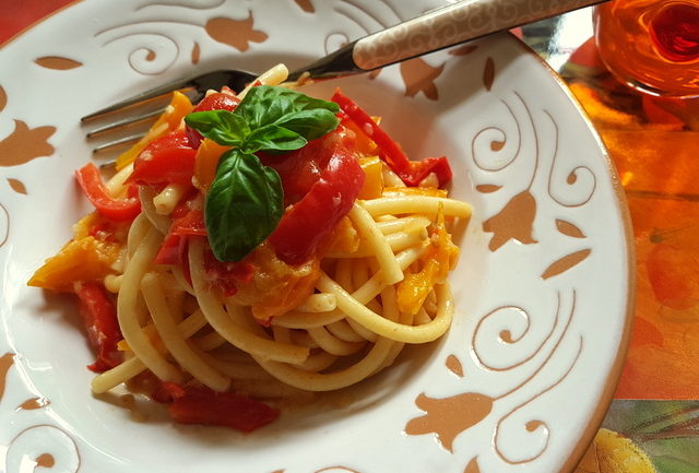 Bucatini with red and yellow cherry tomatoes and peppers