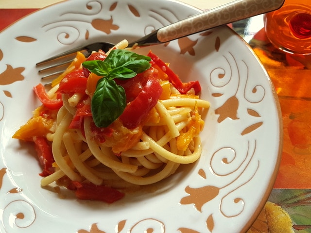 Bucatini with red and yellow cherry tomatoes and peppers