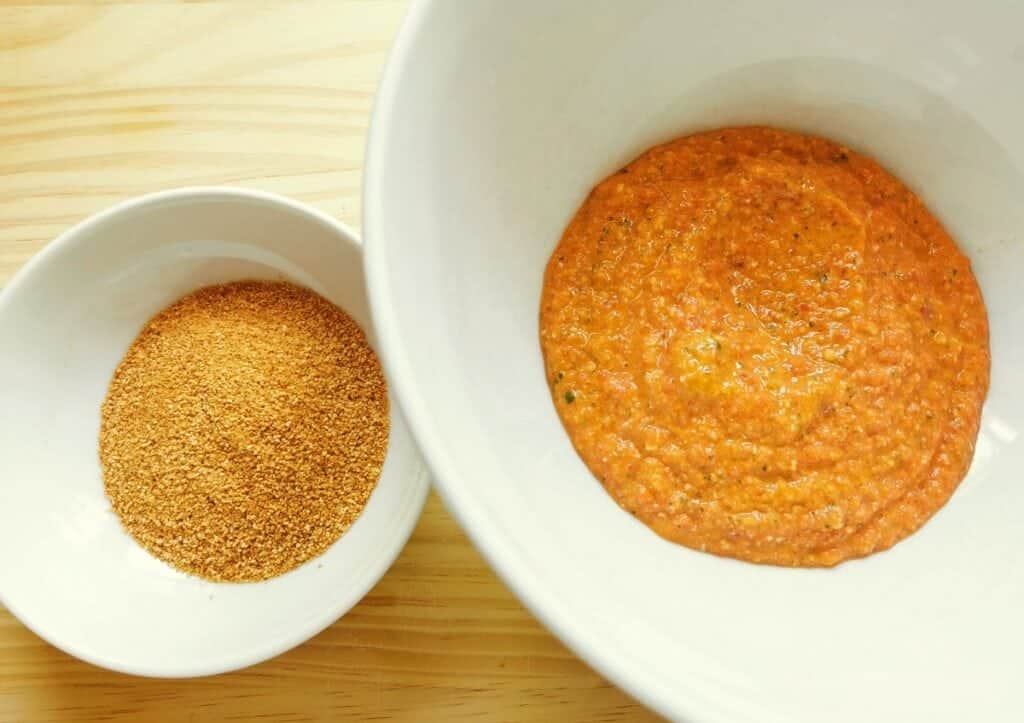 some Trapanese pesto in large white bowl and toasted breadcrumbs in second white bowl