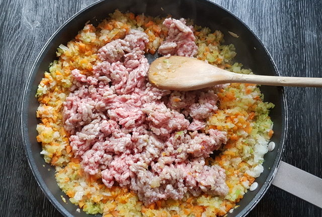 minced veal, carrots, onions and celery in frying pan