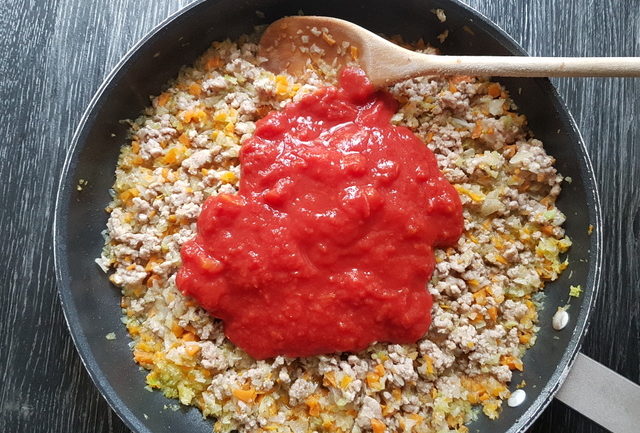 tomato passata, minced veal, onions, carrots and celery in frying pan