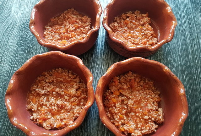 meat ragu in terracotta pots