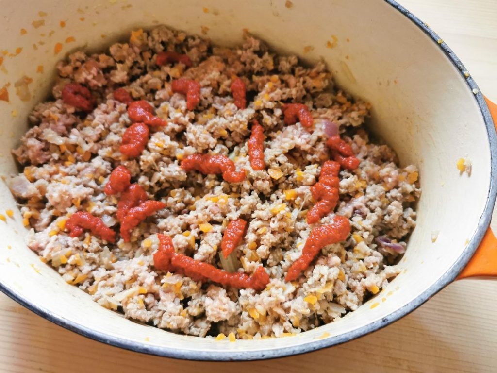 tomato paste added to browned meat in Ducth oven