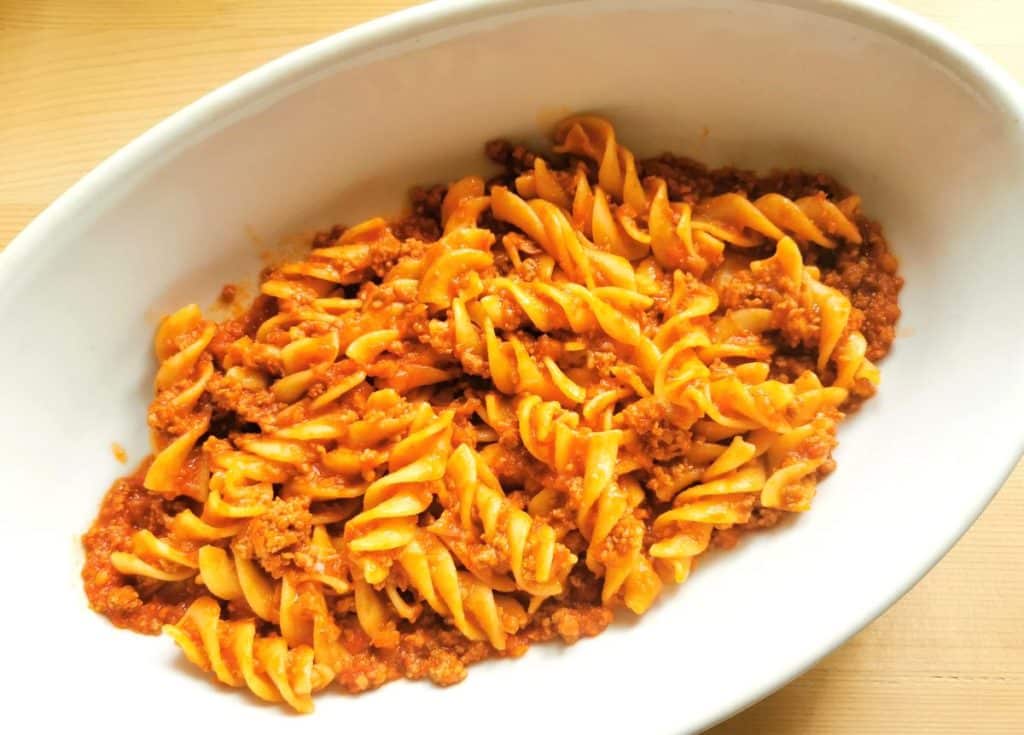 mixed pasta and ragu in oven dish