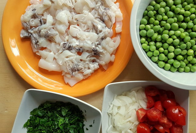 shelled fresh peas, cleaned and cut cuttlefish, chopped parsley, tomatoes and onions