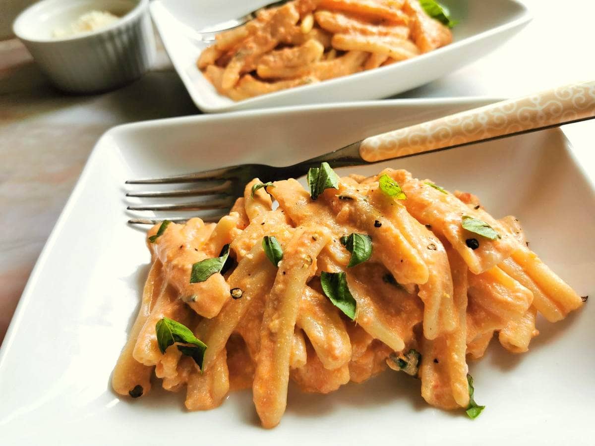 Sicilian pesto pasta in a bowl with a fork and basil 