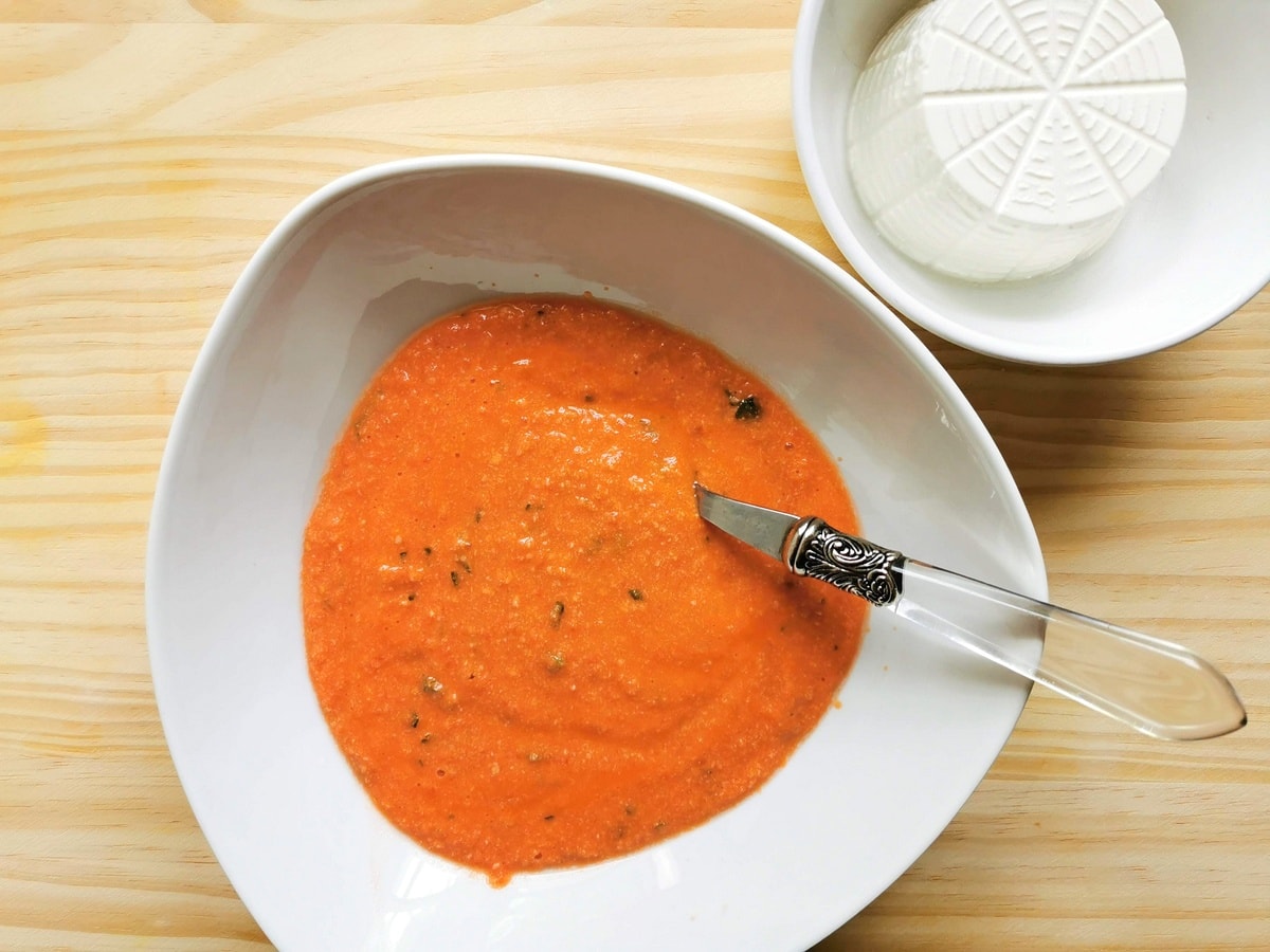 Sicilian pesto in a bowl next to ricotta.