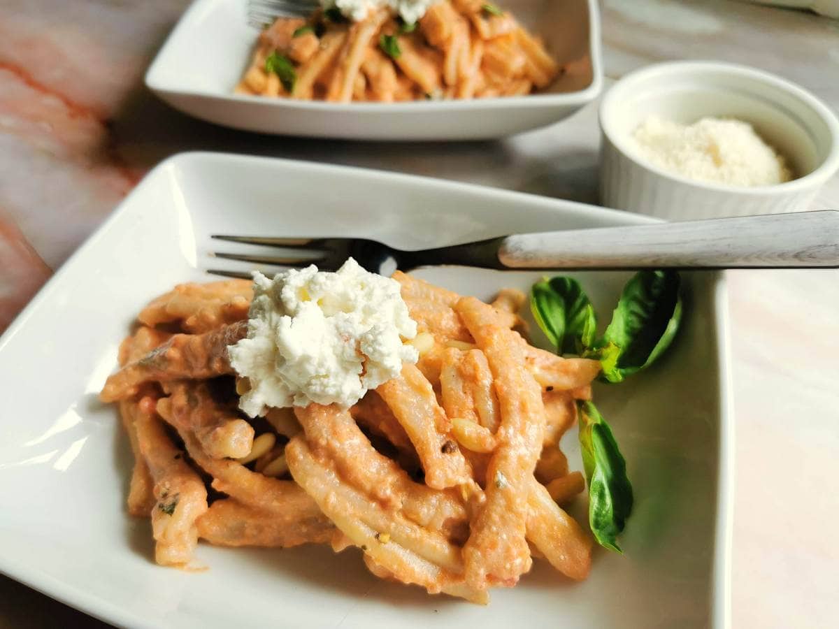 Sicilian pesto with casarecce pasta in a white bowl