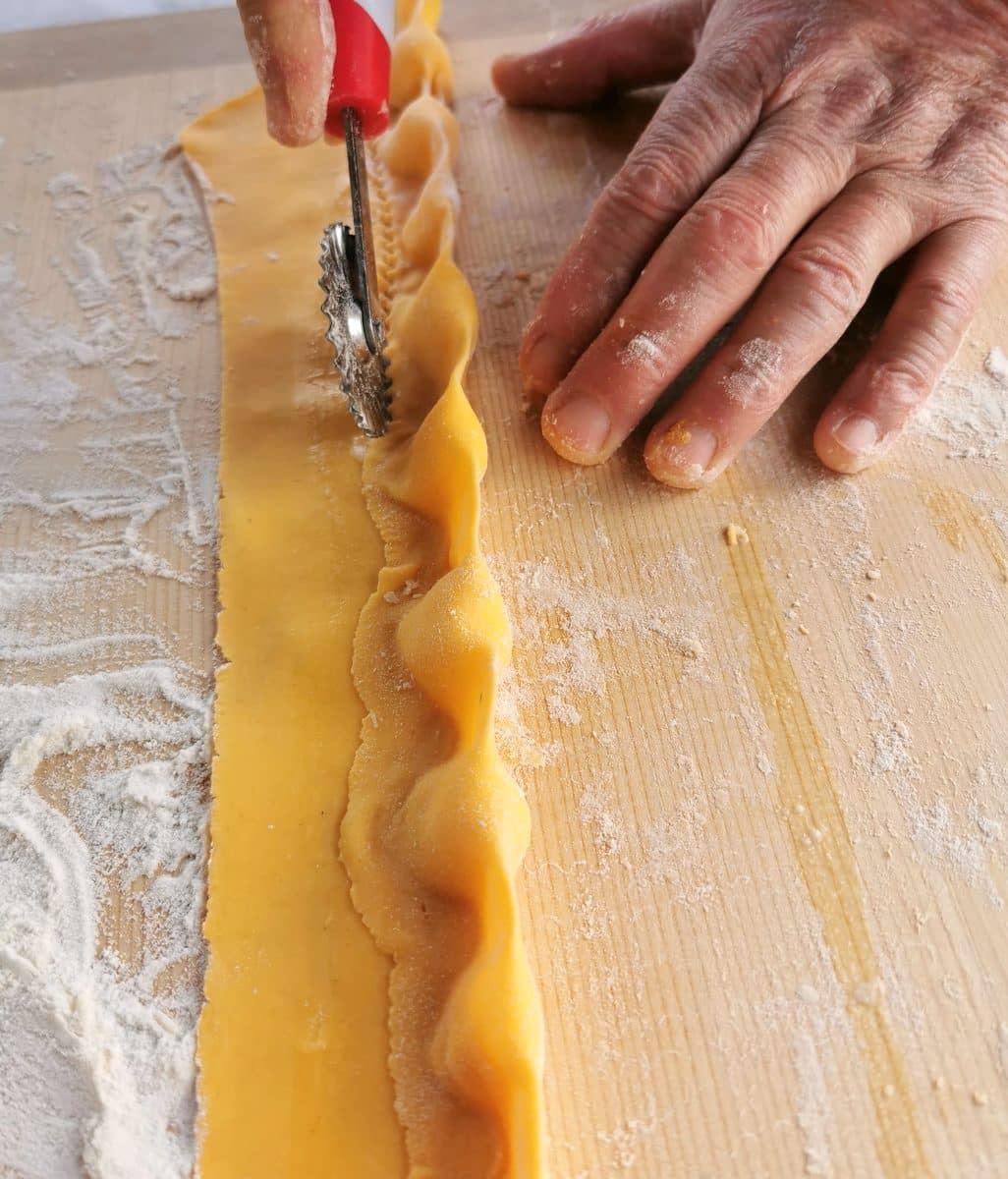 Using a pasta wheel cutter to cut the agnolotti