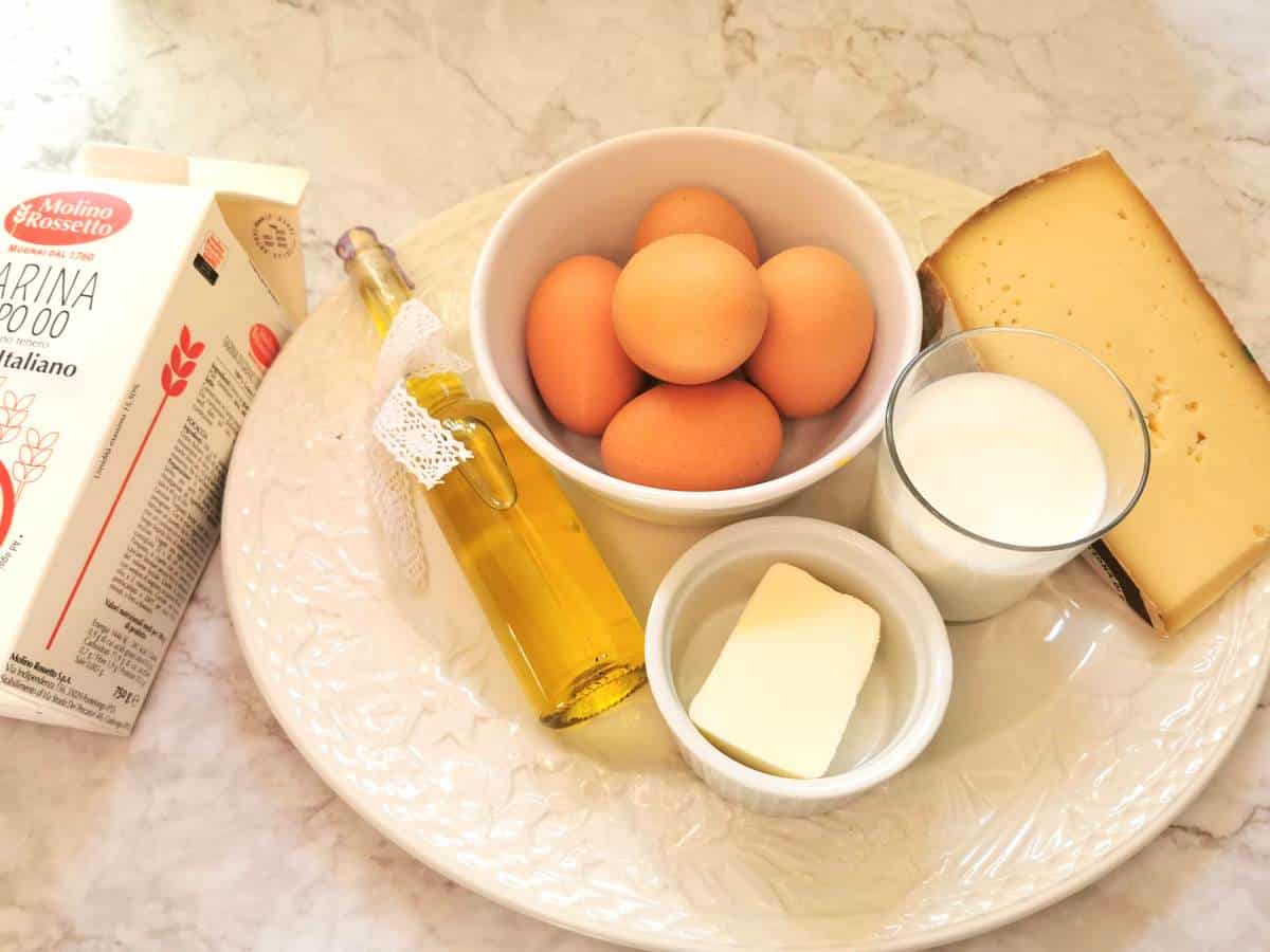 Ingredients to make agnolotti in white bowls