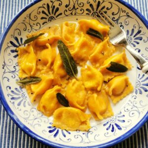 Agnolotti del plin pasta recipe in a bowl with sage.