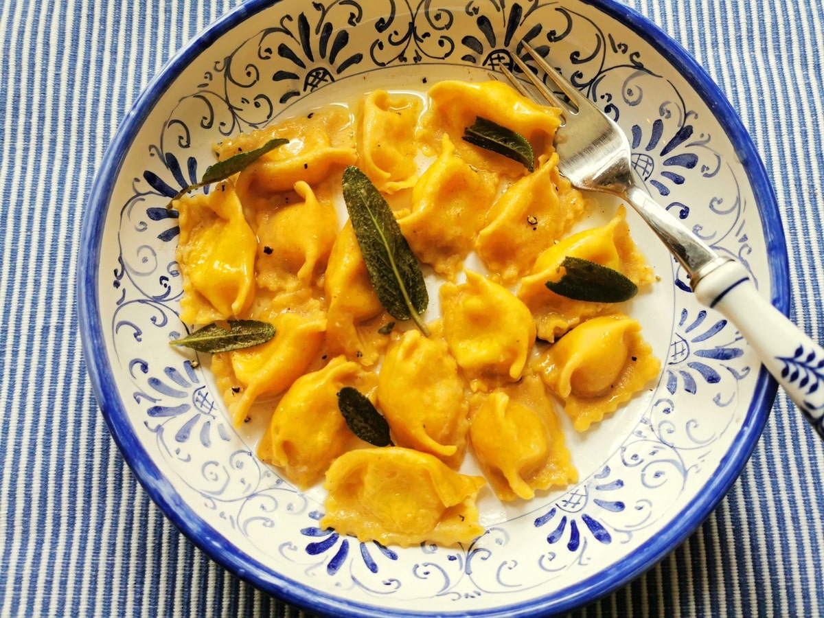 Agnolotti del plin pasta recipe in a bowl with sage.