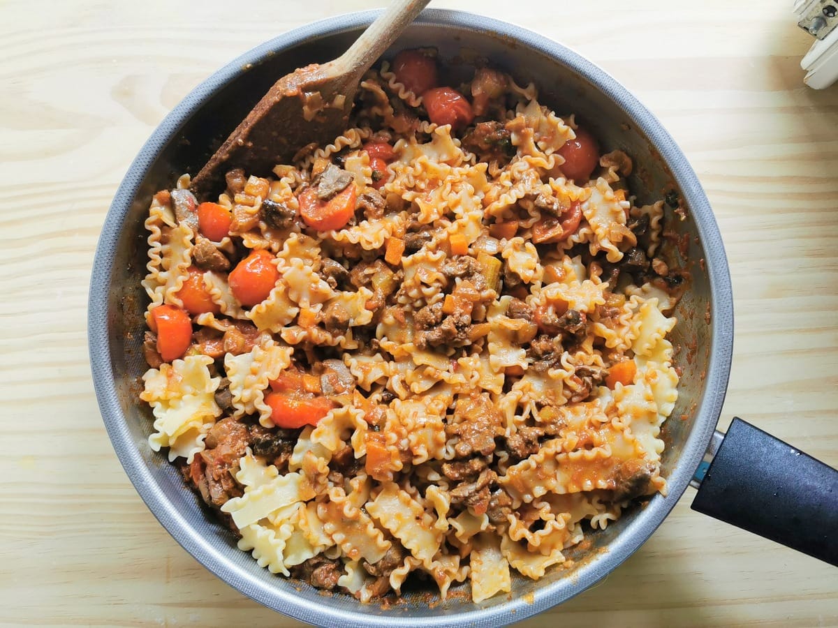 ready chicken liver pasta with porcini in deep frying pan