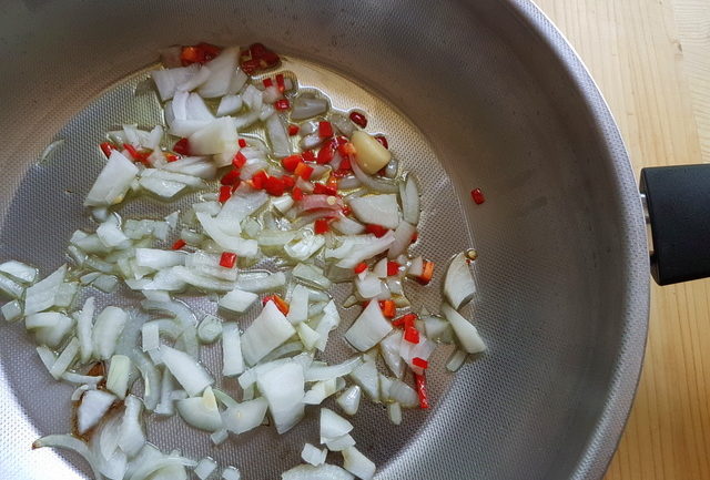 onions, garlic and peperoncino in frying pan