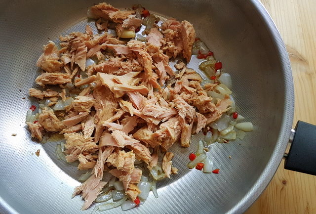 tuna fillet, onions, garlic and peperoncino in frying pan