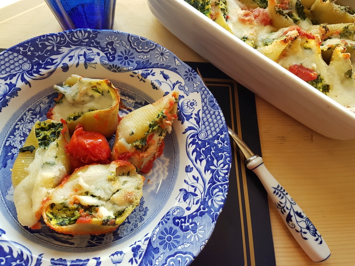 Baked conchiglioni pasta shells filled with spinach and ricotta.