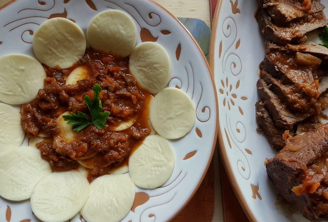 Corzetti or Croxetti pasta with genovese sauce 'tocco di carne'