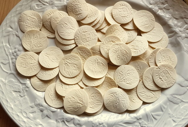 Dried corzetti on white plate for pasta Liguria with pesto, potatoes and green beans. 