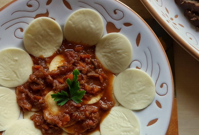 Corzetti pasta with Genovese meat sauce (al tocco di carne)