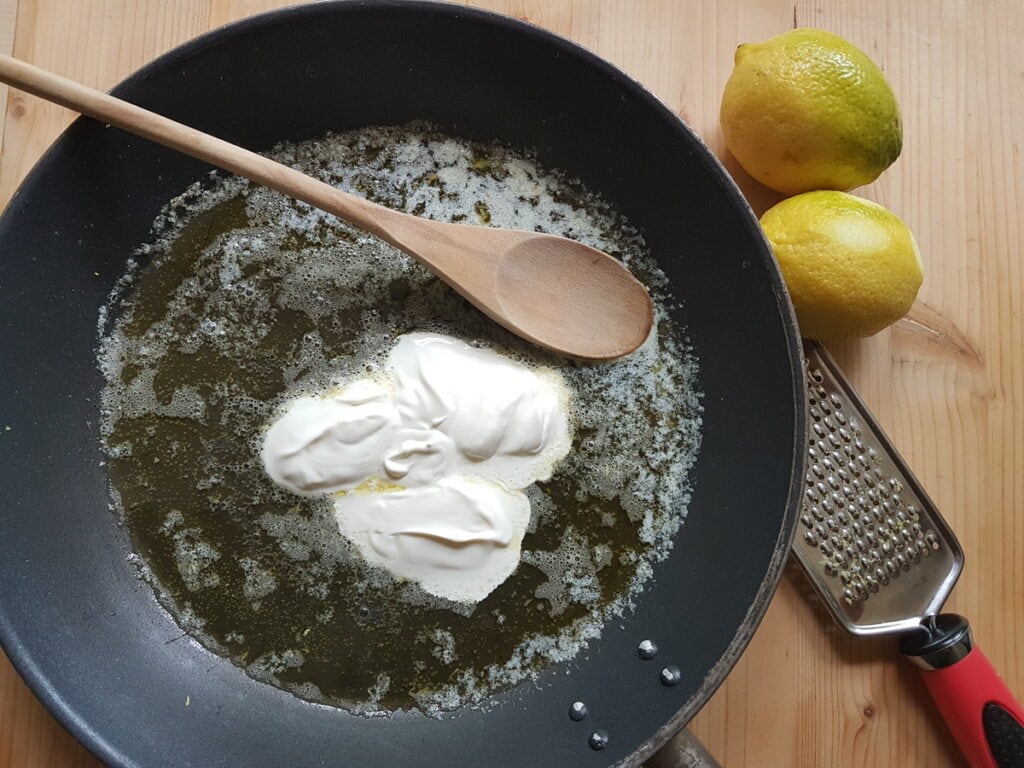 heavy cream in skillet with the butter and lemon zest