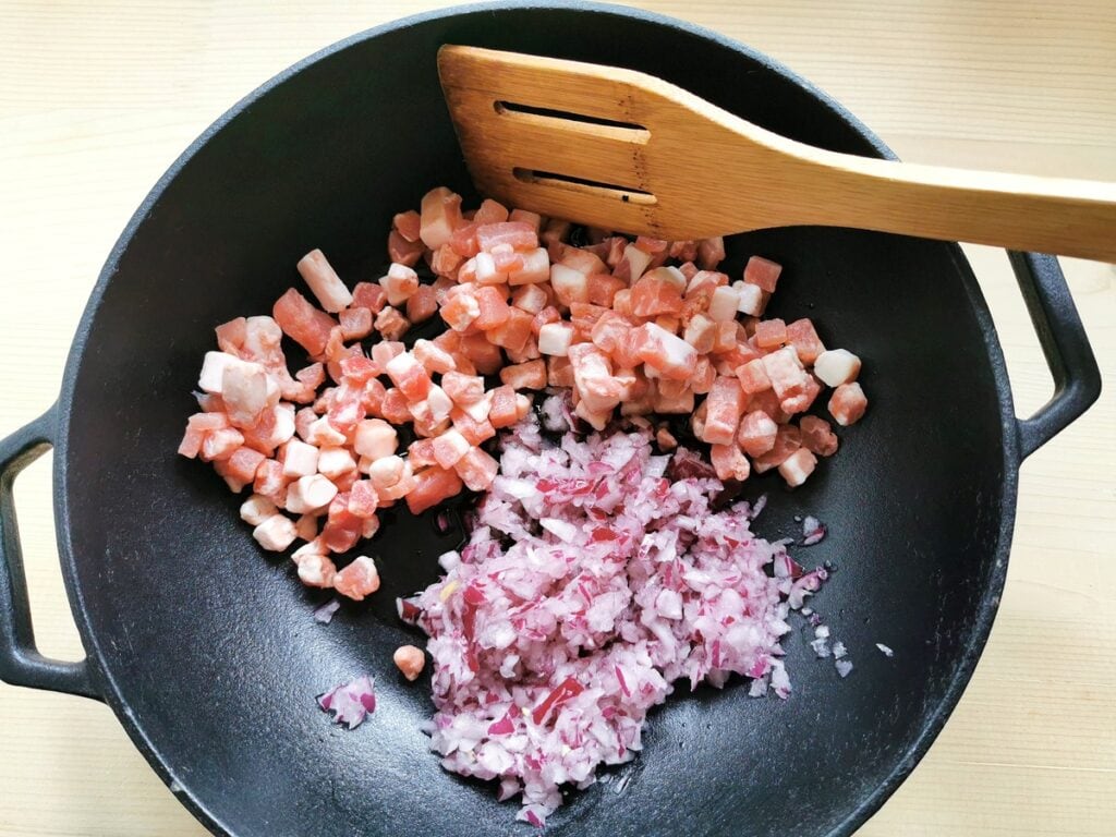 chopped onion and pancetta in skillet